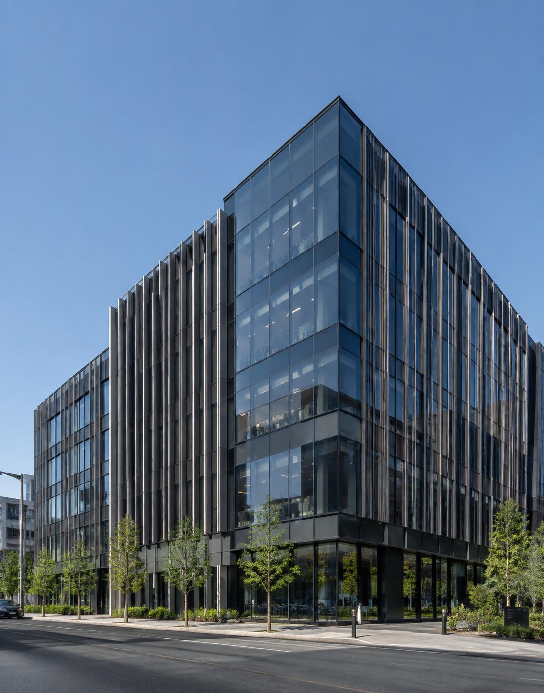 Modern office building with dark glass curtainwall and metal fins