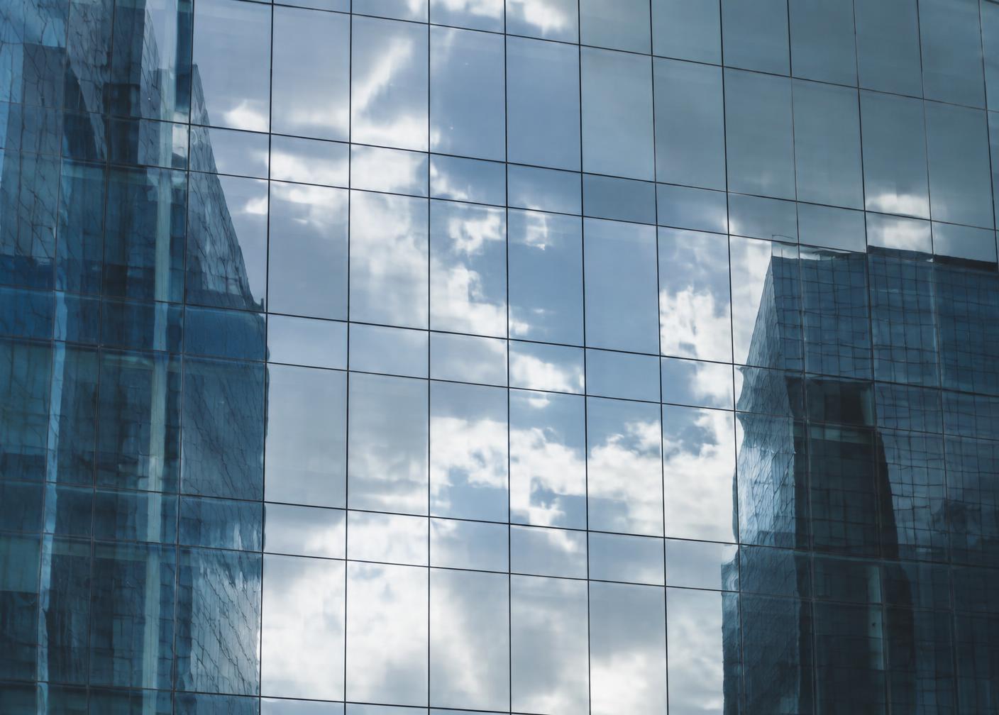 Clouds reflected in a flat commercial glass facade
