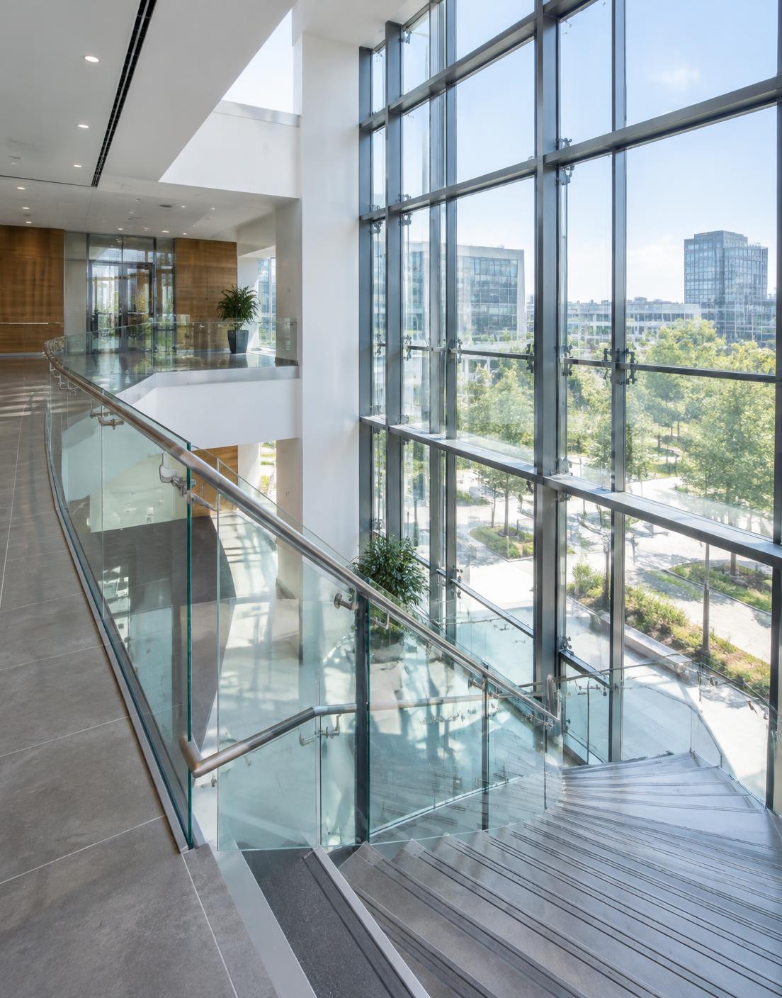 Glass balustrade and glazed atrium wall inside a commercial building