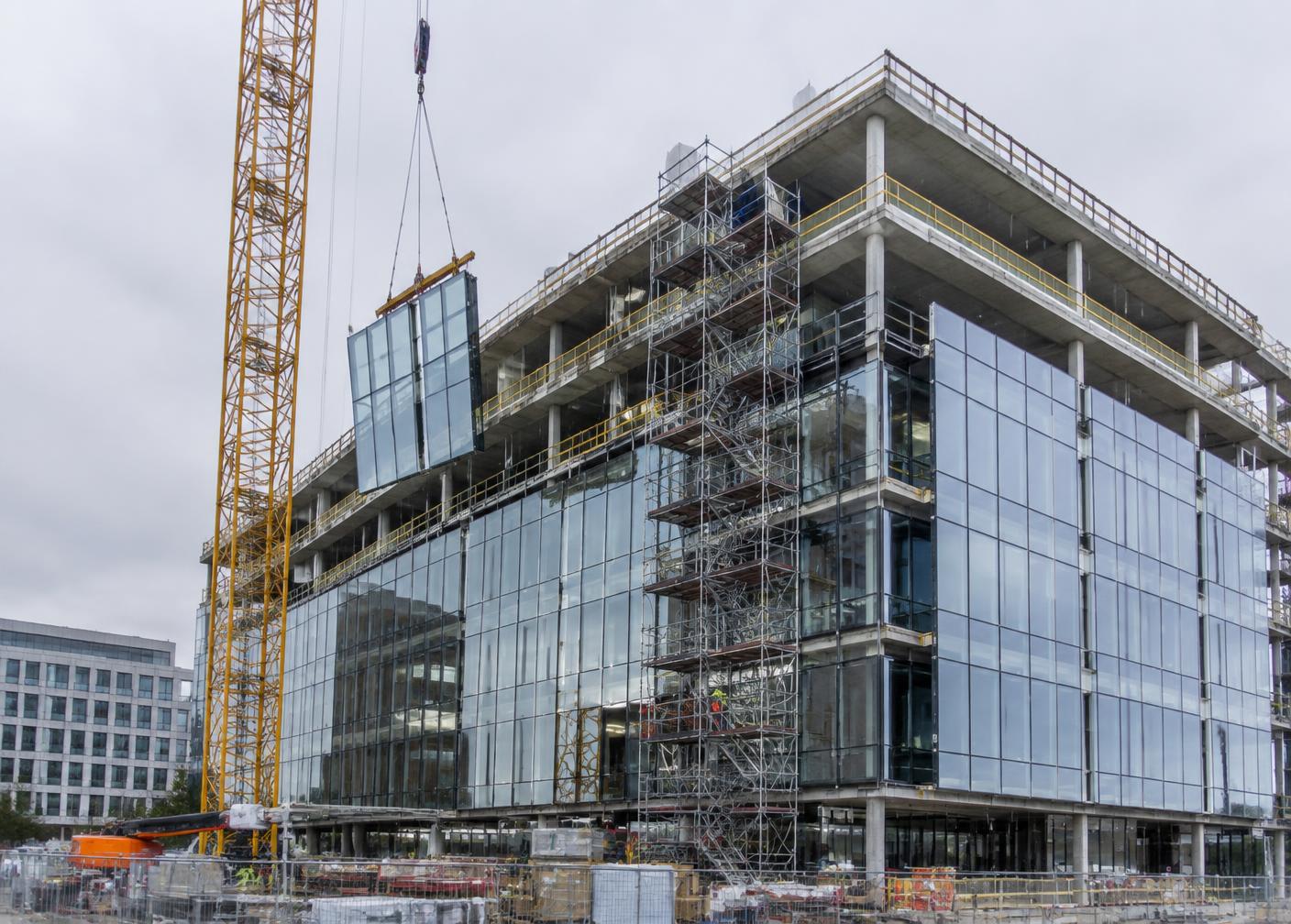 Curtainwall glazing being installed on a commercial building under construction