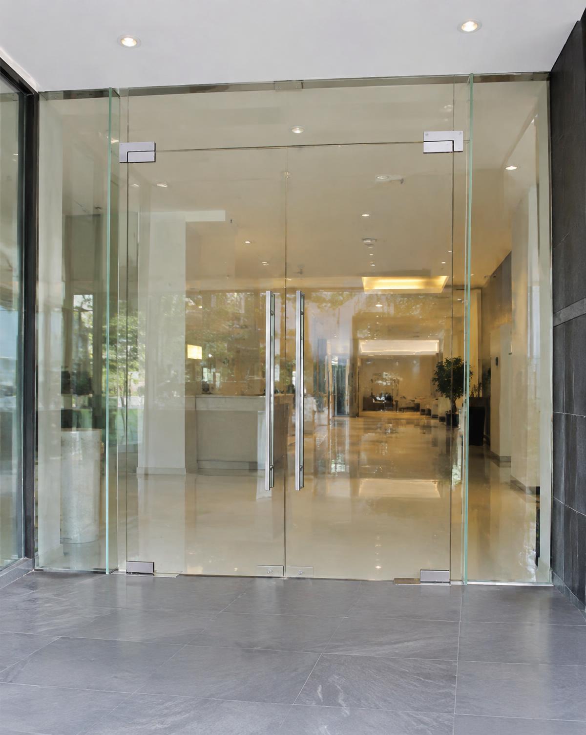All-glass commercial entrance doors with sidelights and patch fittings