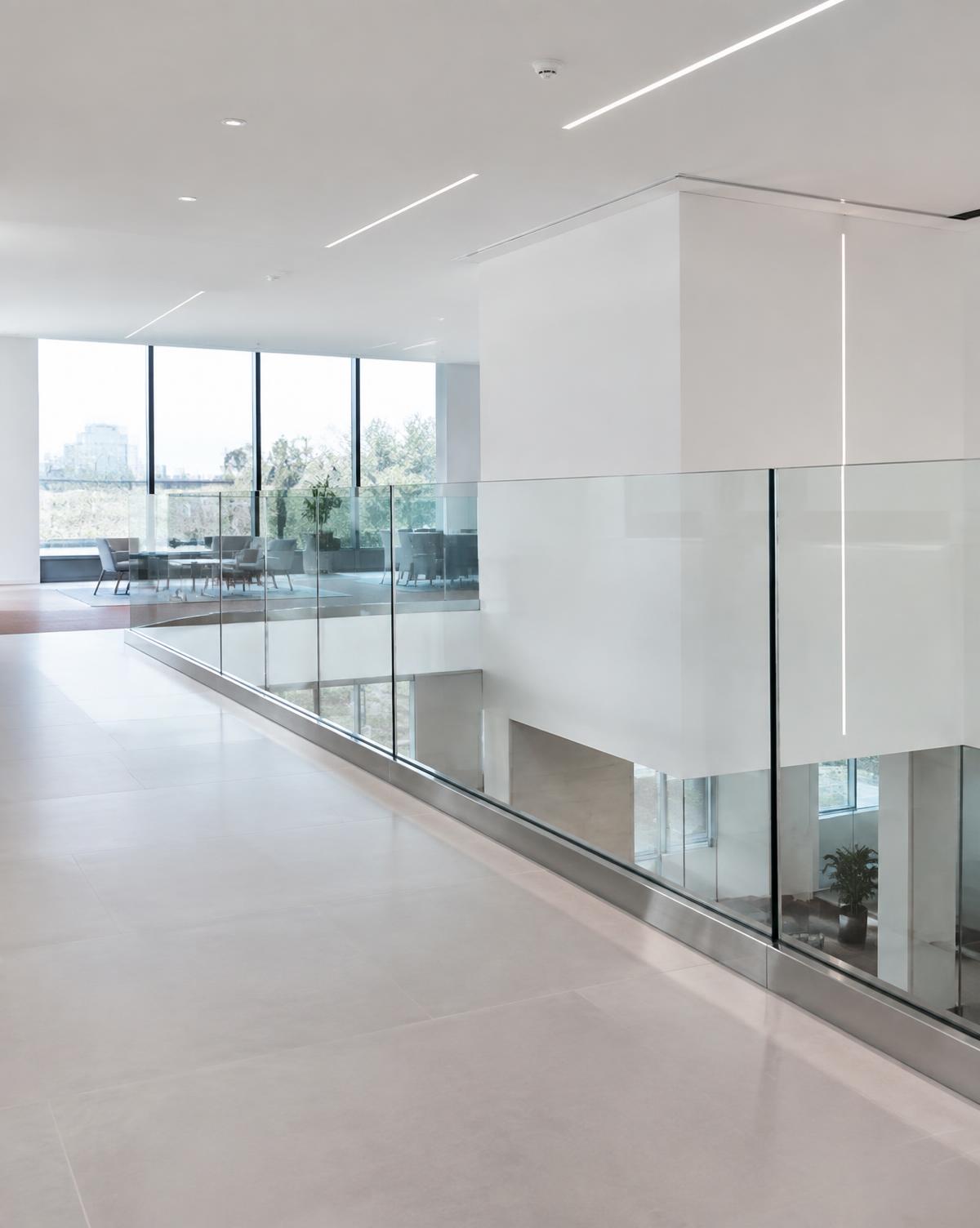 Frameless glass handrail system on a commercial mezzanine